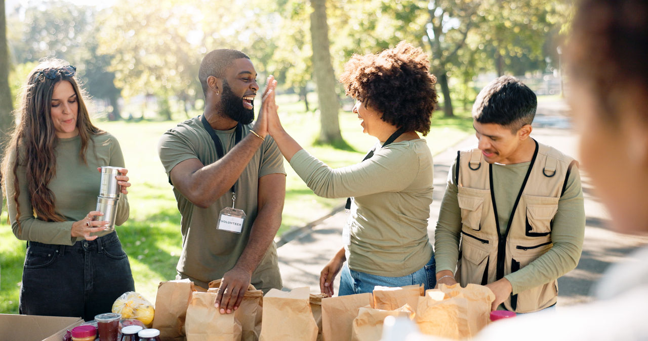 community workers high-five at community event