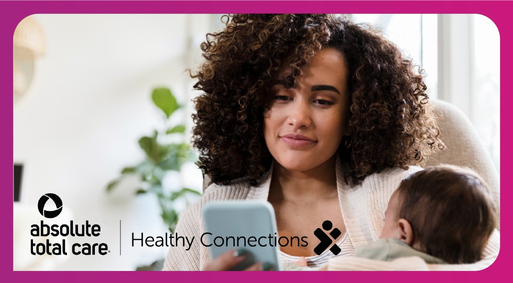 mobile app banner; woman holding baby and looking at mobile phone